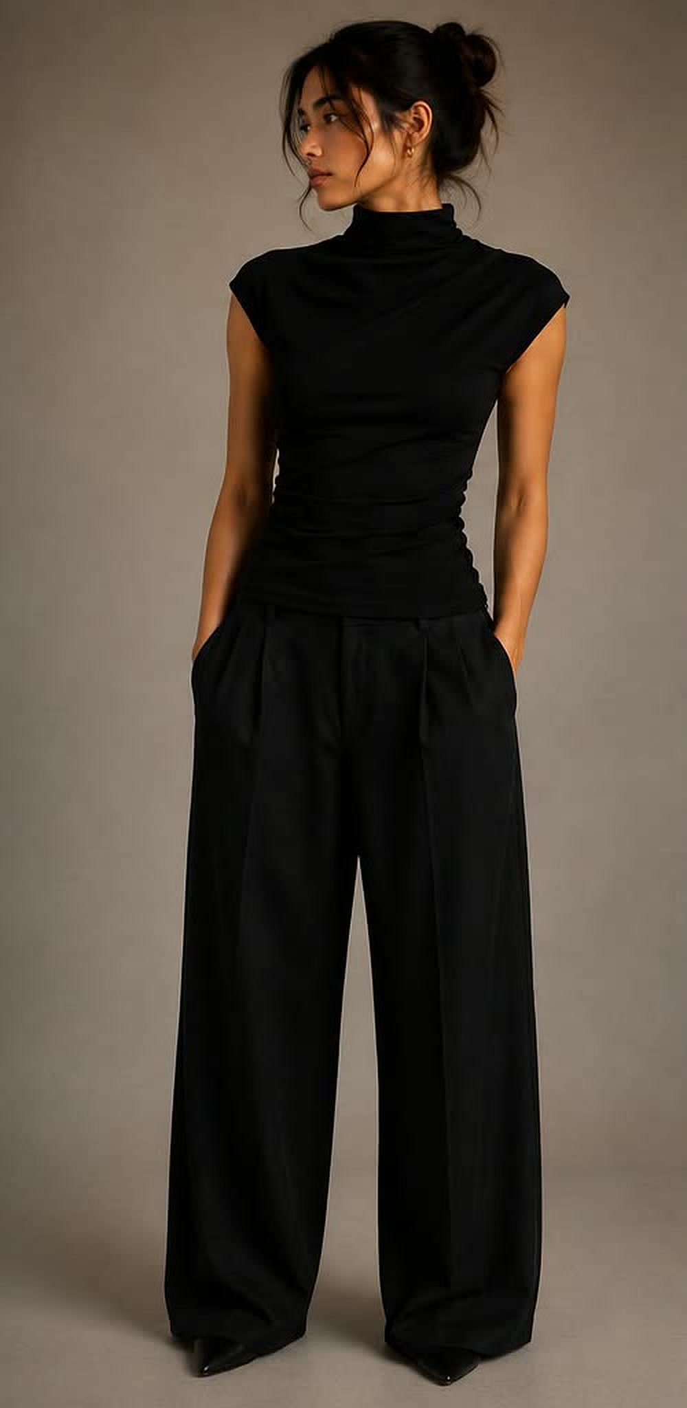Black draped high-neck top with cap sleeves and wide-leg trousers, front view