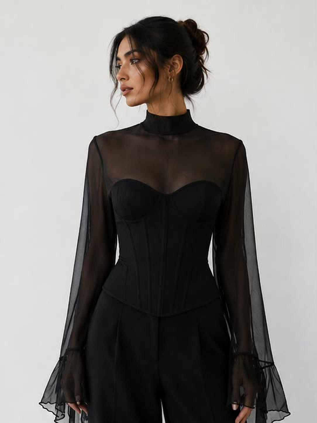 Black corset top with a sheer chiffon yoke and long bell sleeves