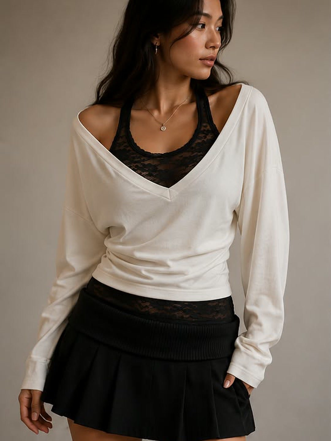 Ivory layered top over a black lace tank and pleated mini