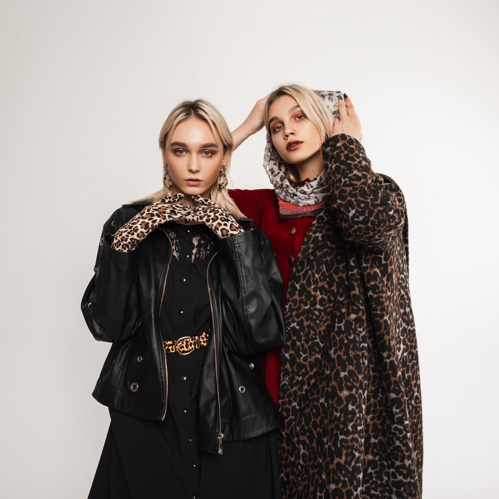 Two women in a leopard-print coat and a black leather jacket