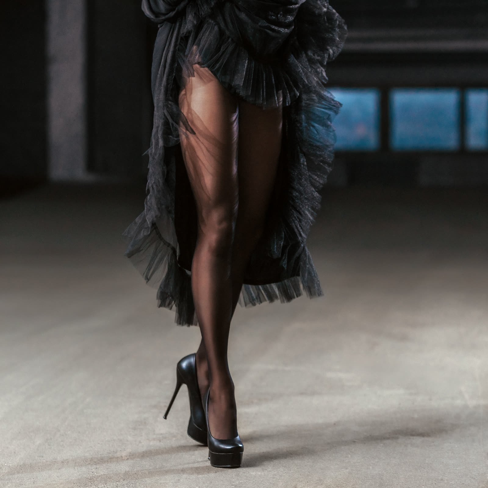Black tulle and chiffon skirt over sheer black tights and platform heels