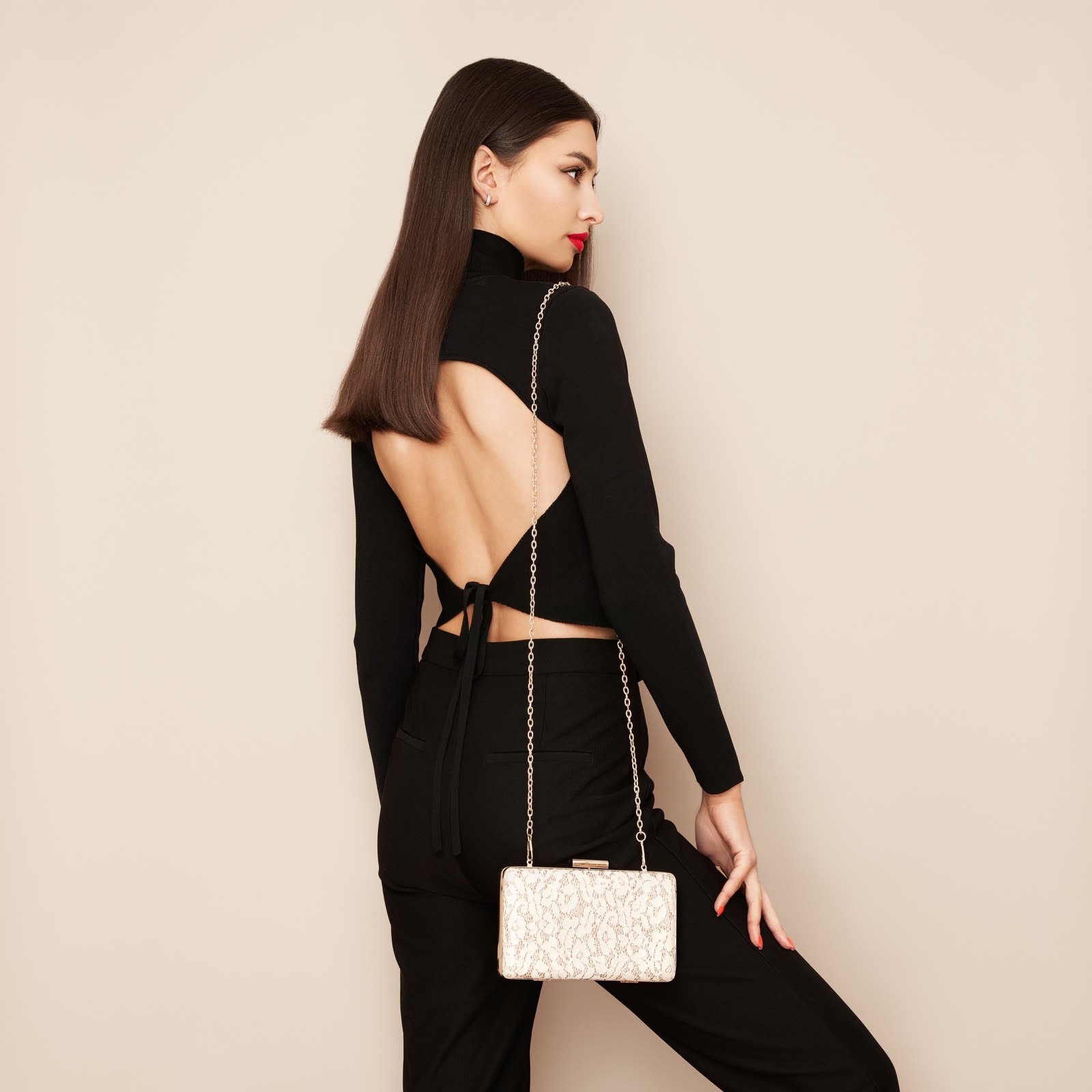 Back view of a black long-sleeve top with a cut-out open back and a tie