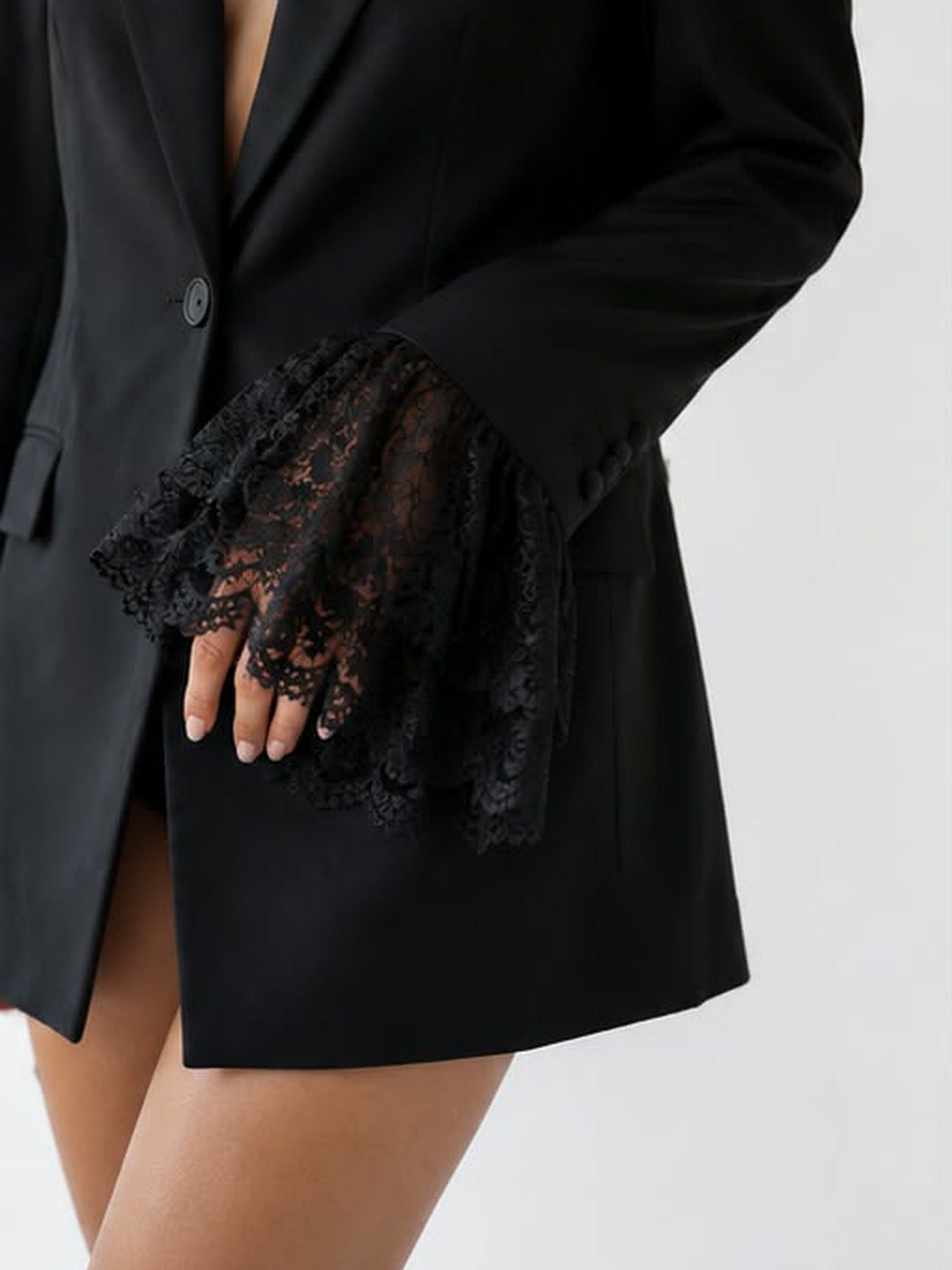 Lace cuff of a black blazer